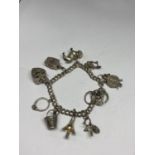 A SILVER CHARM BRACELET WITH TEN CHARMS