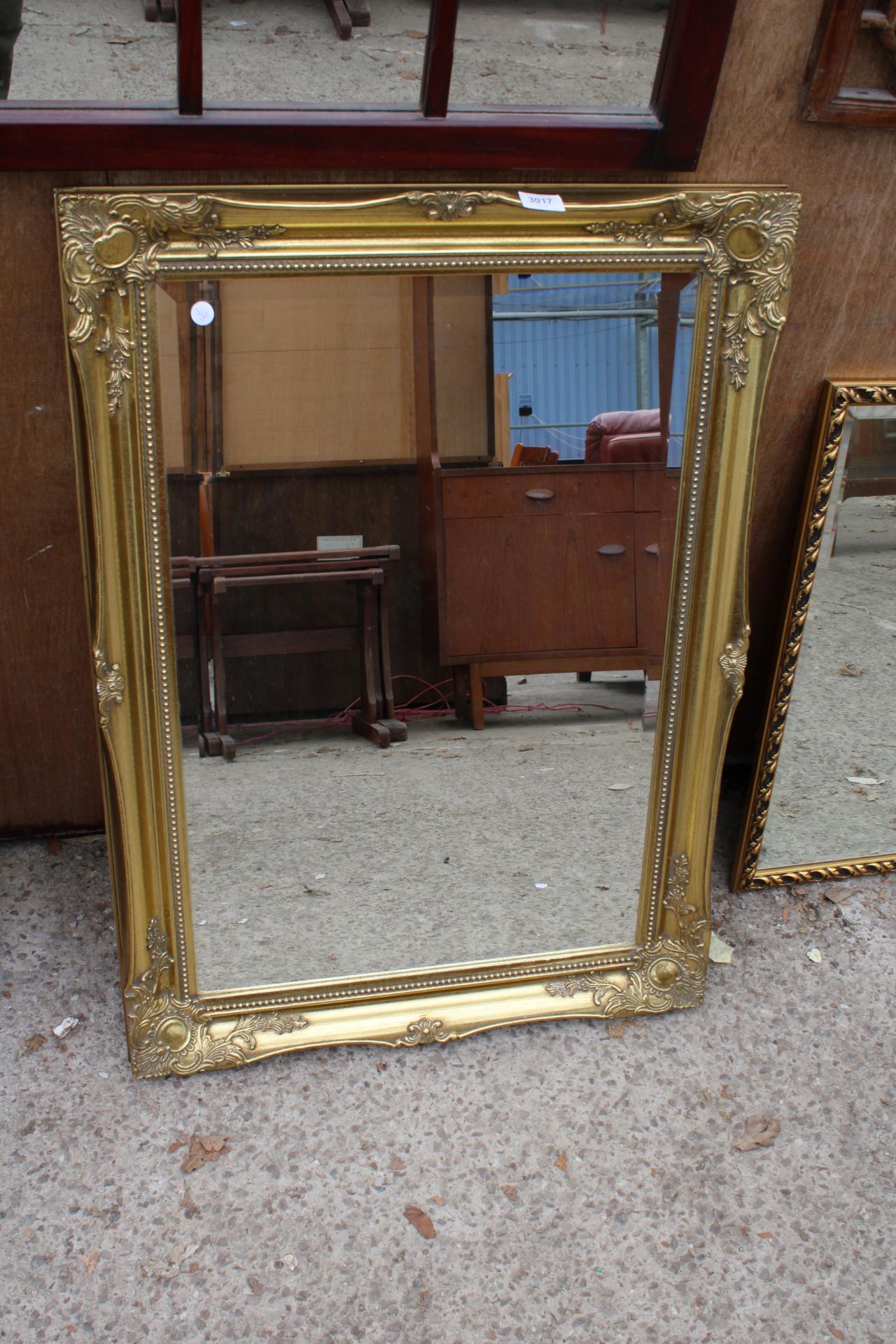 A JARSON-JUHL GILT FRAMED BEVEL EDGE WALL MIRROR 36" X 24"