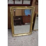 A JARSON-JUHL GILT FRAMED BEVEL EDGE WALL MIRROR 36" X 24"