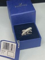 A SWAROVSKI CRYSTAL RING SIZE M/N WITH LABEL IN A PRESENTATION BOX