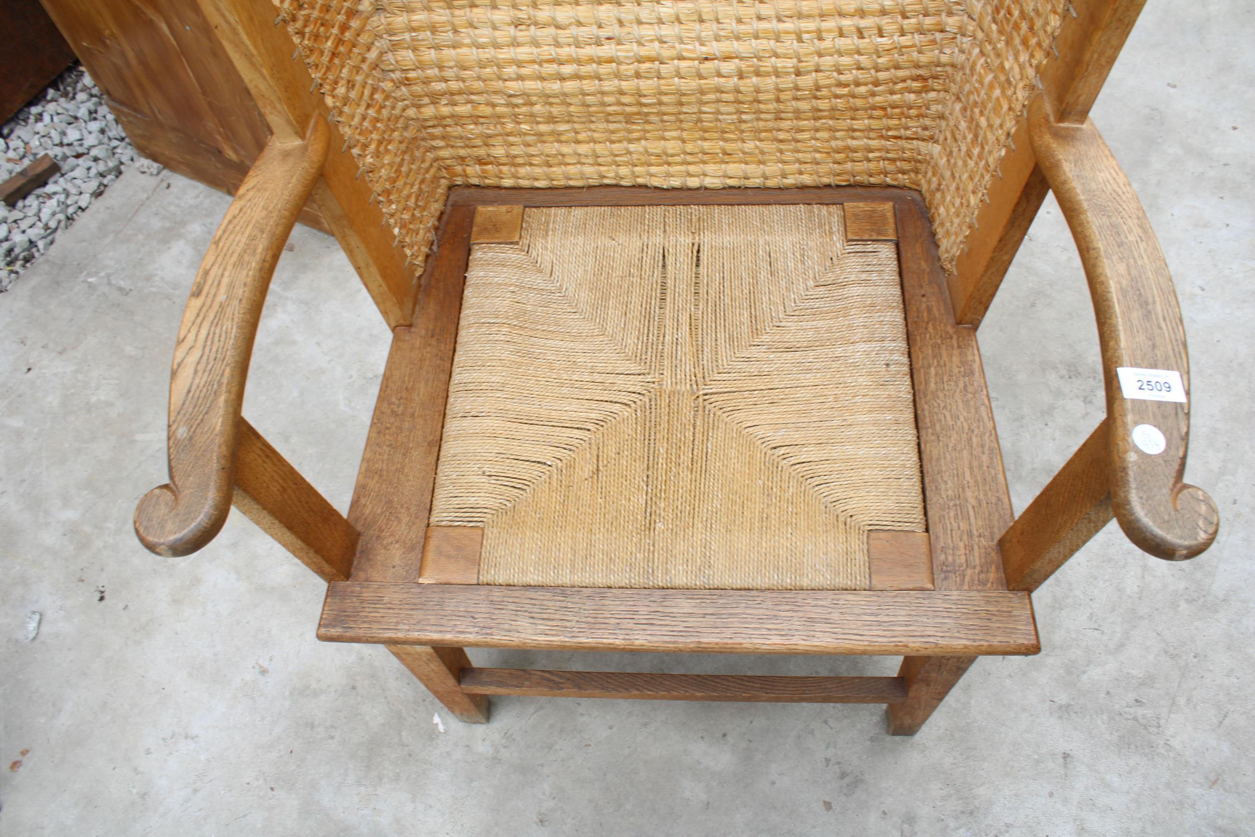 A HOODED OAK FRAMED ORKNEY CHAIR WITH WICKER SEAT AND STITCHED STRAW BACK, STAMPED D M KIRKNESS, - Image 4 of 4