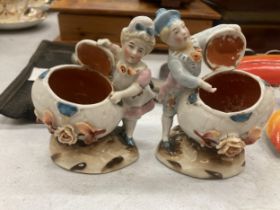 TWO VINTAGE GERMAN MATCHSTICK HOLDER FAIRINGS DEPICTING A LADY AND A MAN WITH AN OPEN FLOWERED SHELL