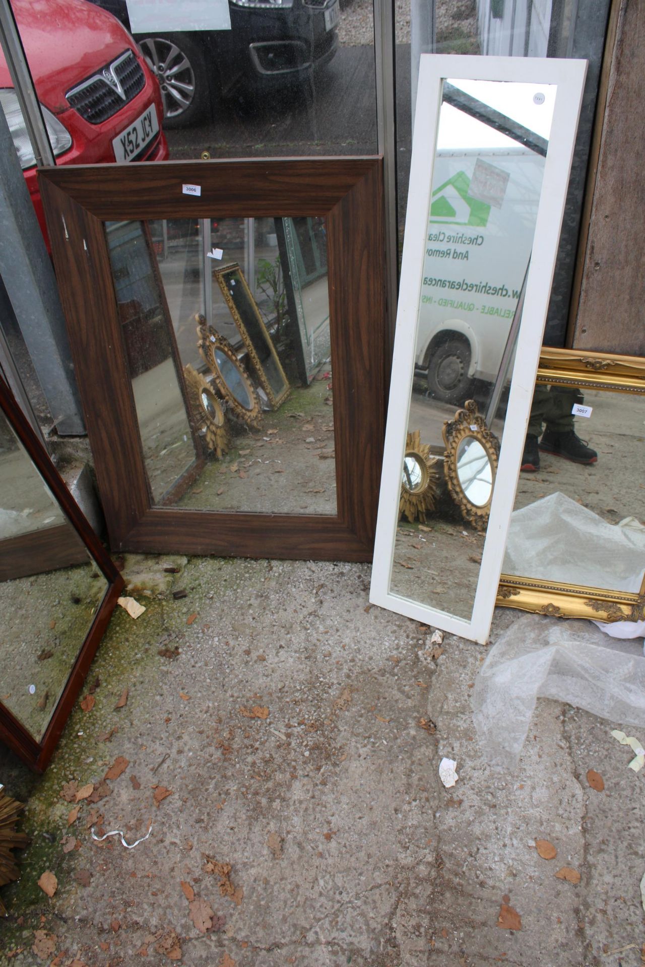 A WOOD EFFECT WALL MIRROR AND A WHITE FRAME MIRROR