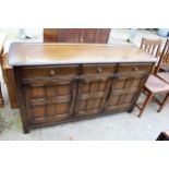 A REPRODUCTION DRESSER BASE ENCLOSING THREE DRAWERS AND THREE CUPBOARDS, 60" WIDE