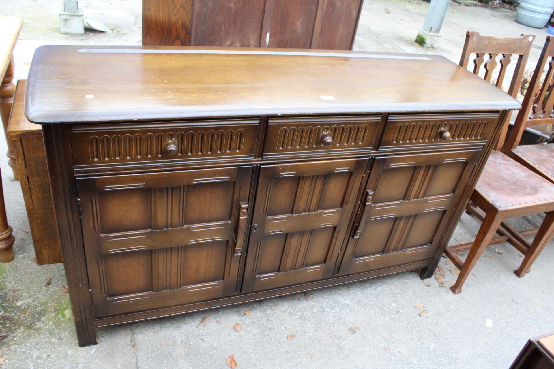 A REPRODUCTION DRESSER BASE ENCLOSING THREE DRAWERS AND THREE CUPBOARDS, 60" WIDE