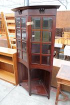 AN EARLY 20TH CENTURY MAHOGANY CORNER CUPBOARD WITH BEVELLED GLASS DOORS ON OPEN BASE 39" WIDE
