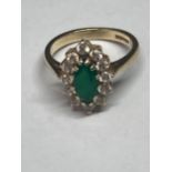 A 9 CARAT GOLD RING WITH A CENTRE EMERALD SURROUNDED BY CUBIC ZIRCONIAS SIZE L