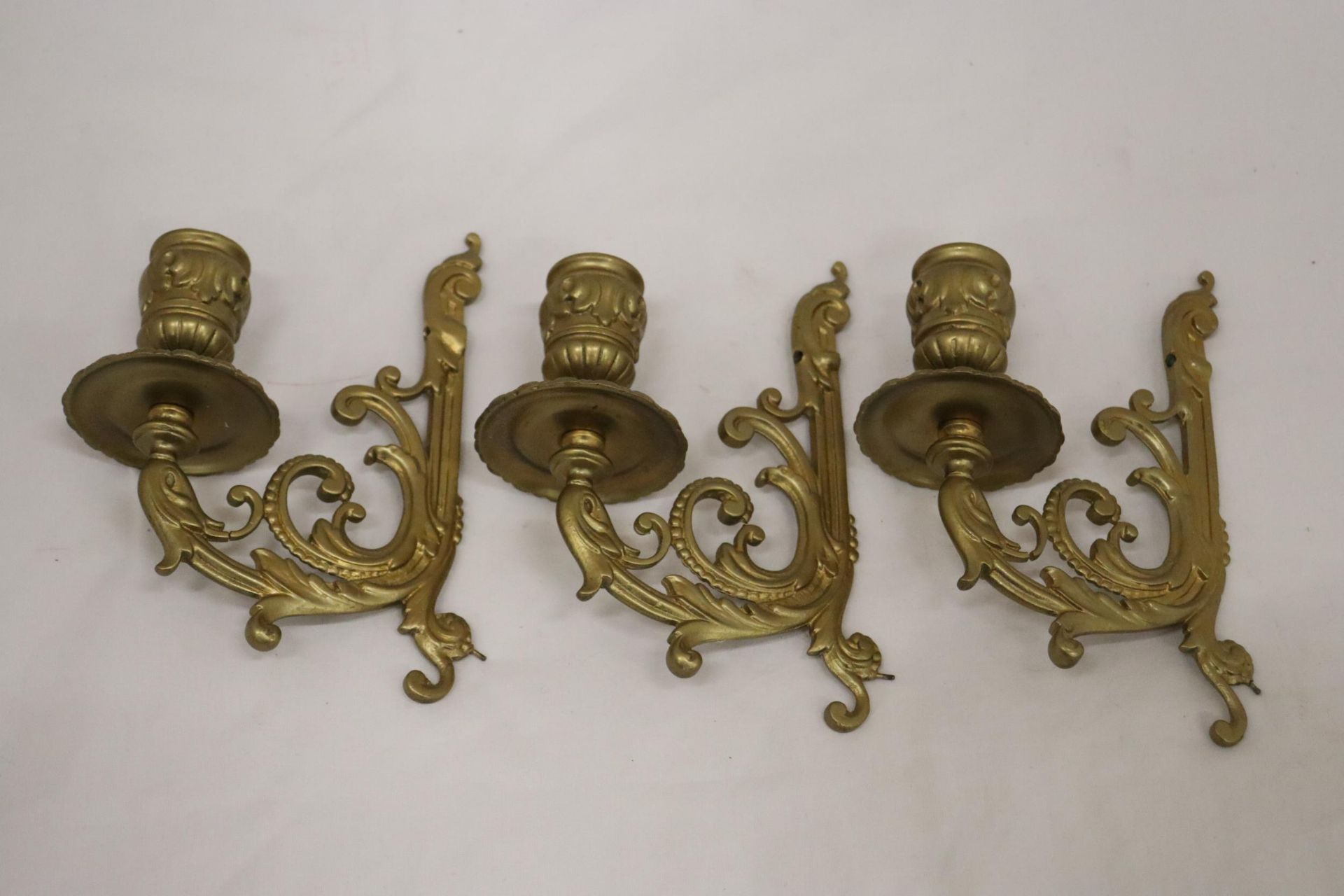 THREE SINGLE ARM WALL CANDLE SCONCES