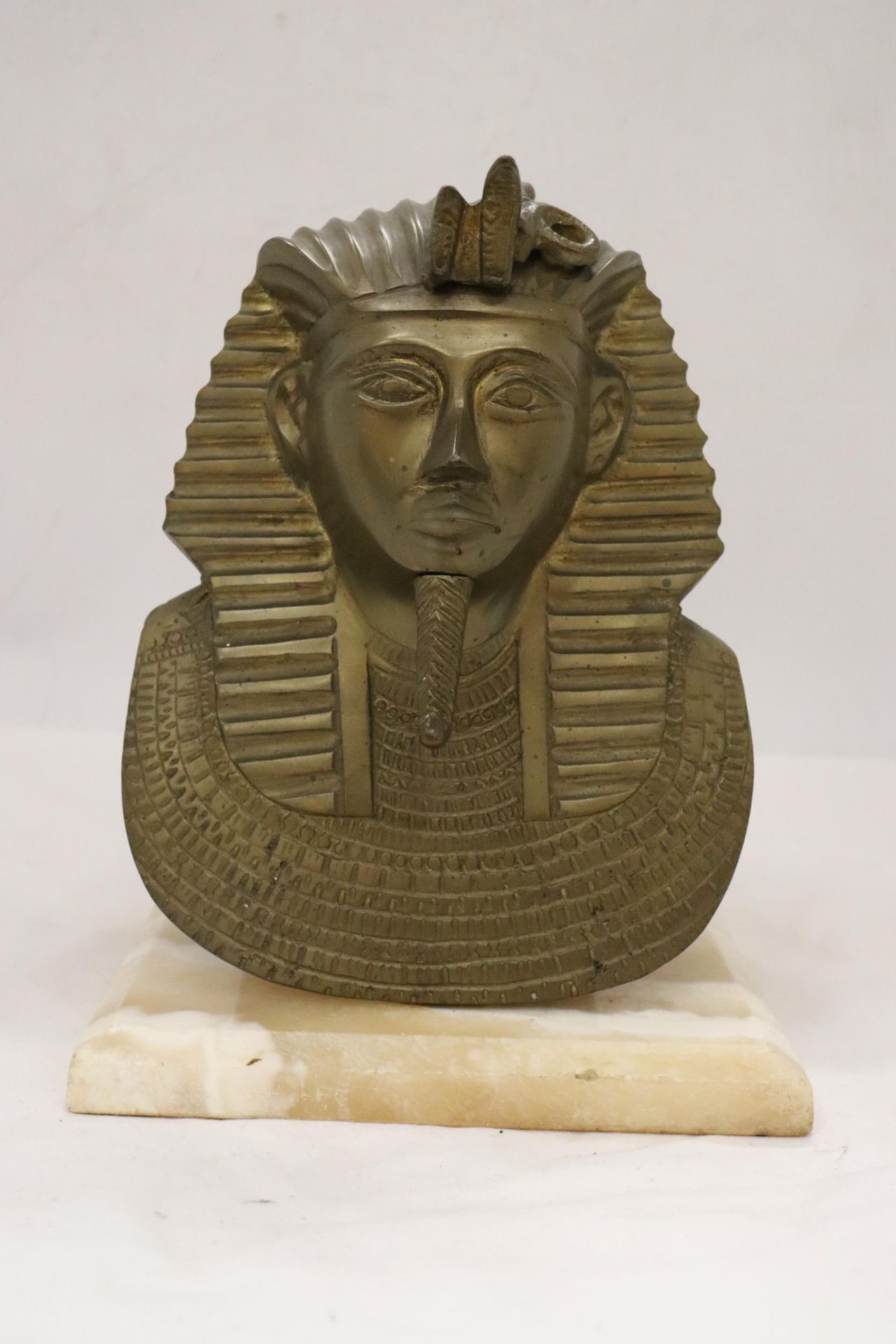A LARGE HEAVY EGYPTIAN HEAD ON MARBLE BASE