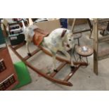 A VINTAGE WOODEN AND FIBRE GLASS CHILDS ROCKING HORSE
