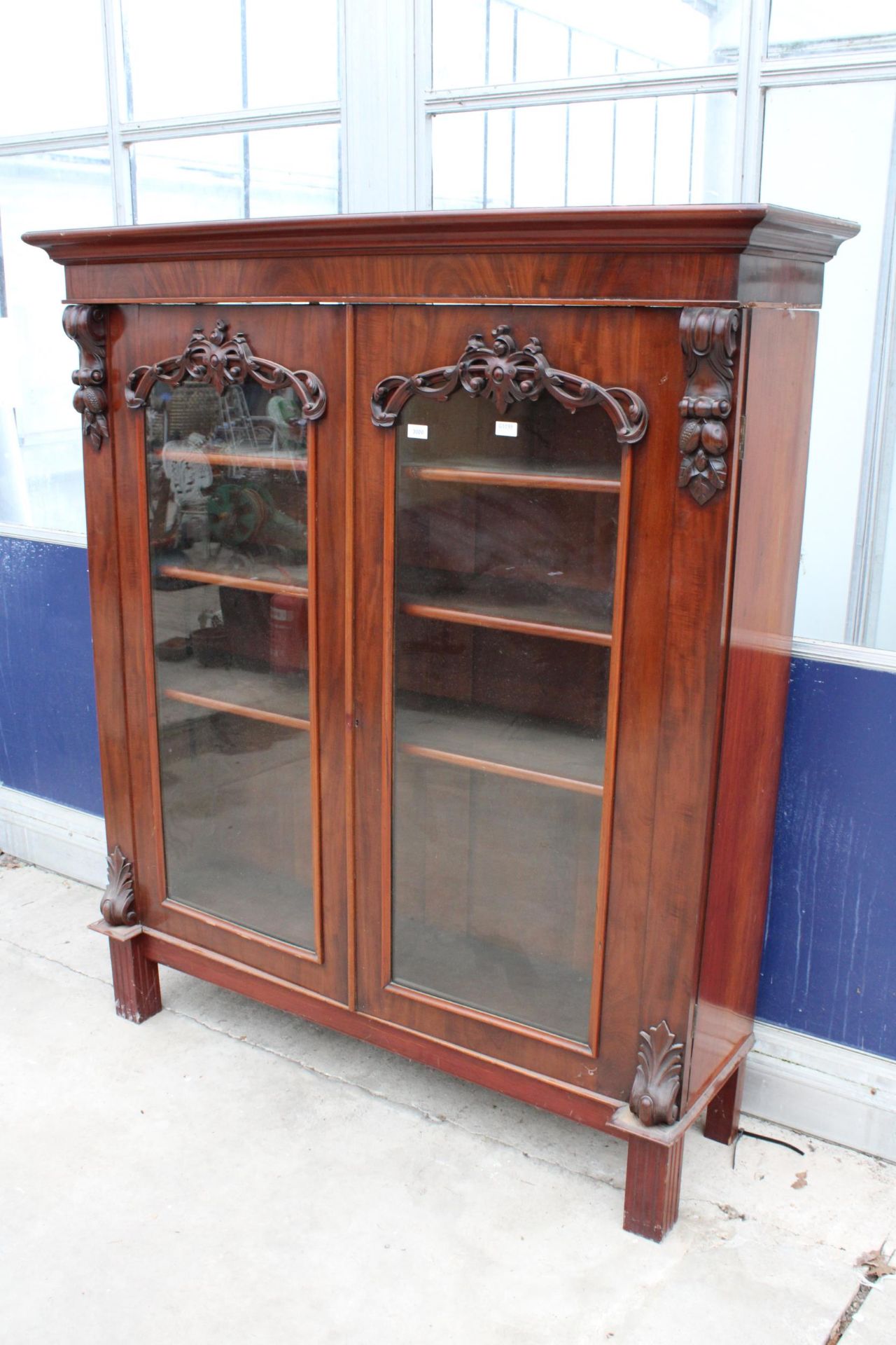 A VICTORIAN MAHOGANY TWO DOOR GLAZED BOOKCASE 59" WIDE