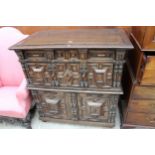 AN OAK CHARLES I STYLE CHEST OF DRAWERS WITH CUPBOARD TO BASE ENCLOSING TWO NINE BOTTLE