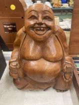 A LARGE WOODEN HAND CARVED BUDDHA