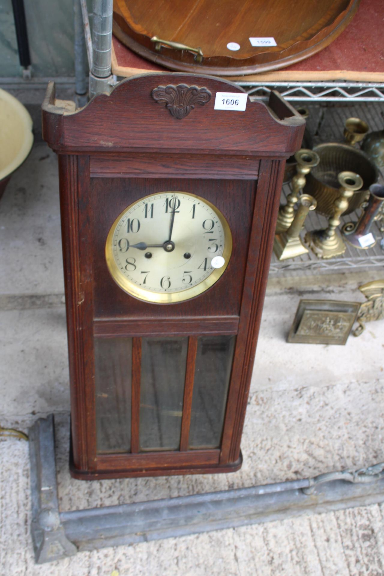 AN OAK CASED CHIMING WALL CLOCK