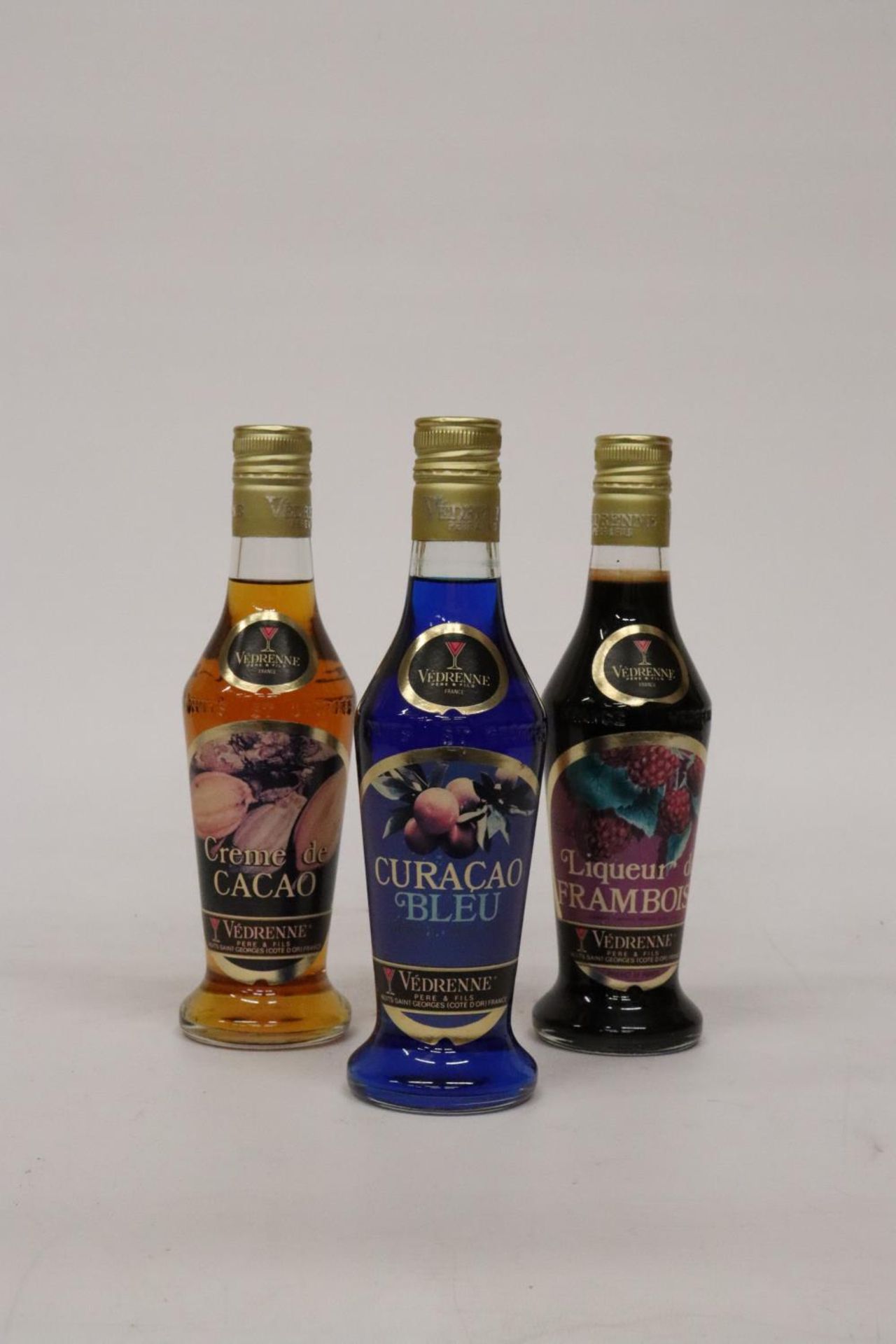 THREE BOTTLES OF VEDRENNE LIQUEUR TO INCLUDE A CURACOA BLEU, A CREME DE CACOA AND A FRAMBOISE