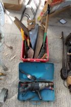 AN ASSORTMENT OF TOOLS TO INCLUDE AN ELECTRIC DRILL, SAWS AND A FORK ETC