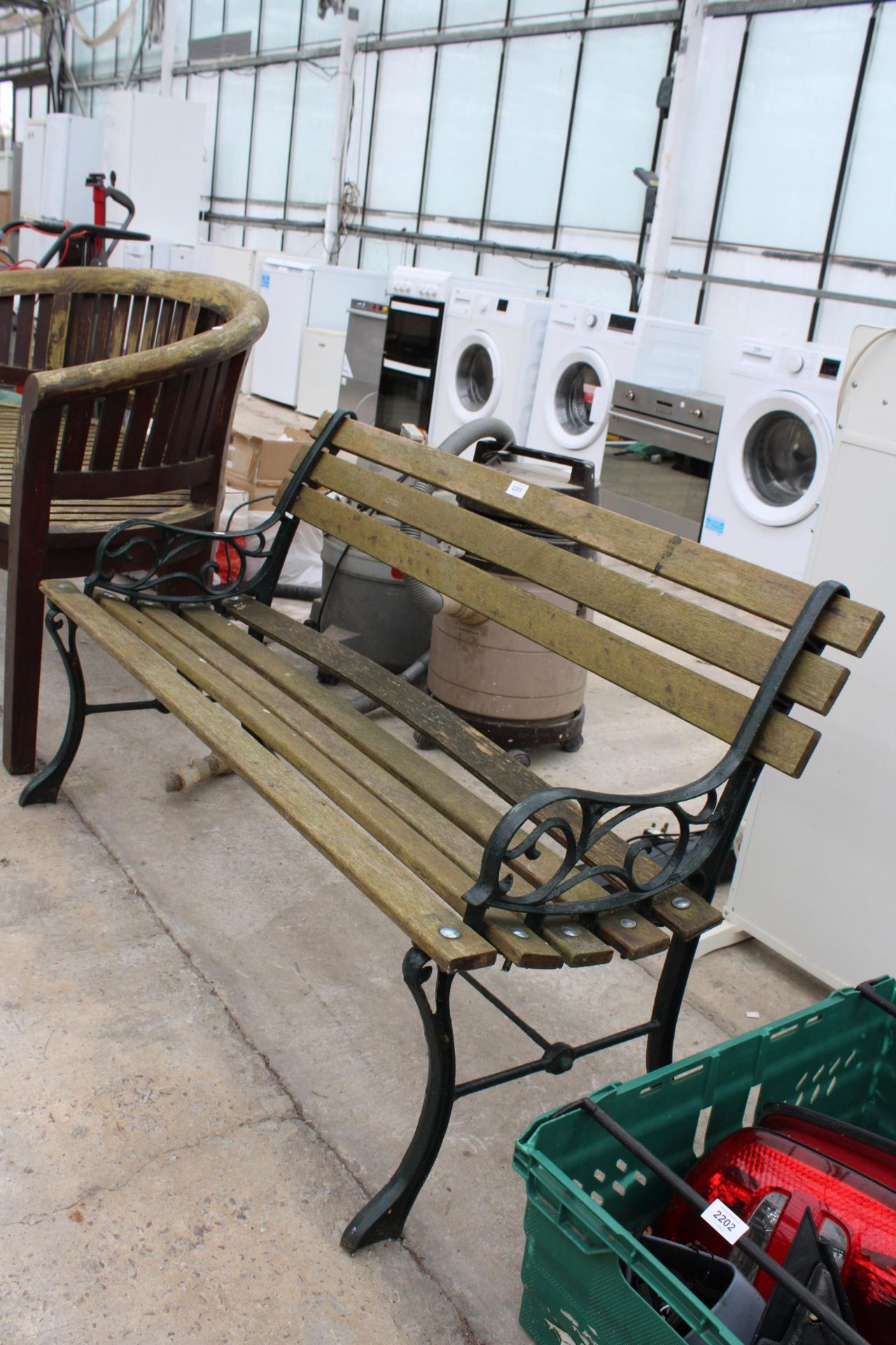 A WOODEN SLATTED GARDEN BENCH WITH CAST ENDS - Image 2 of 2