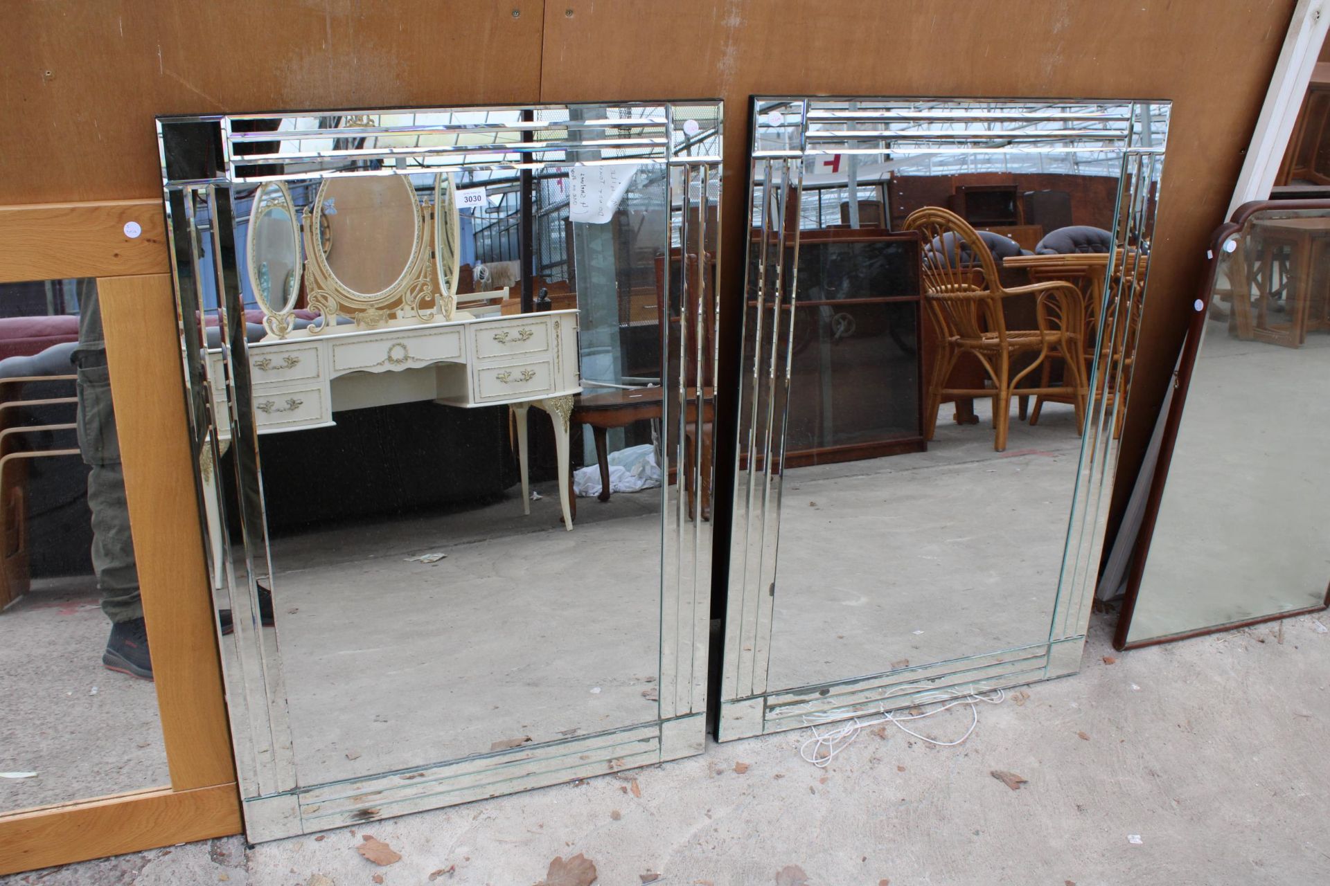 A PAIR OF MIRRORS WITH MODERN UNFRAMED MIRRORS WITH BEVEL EDGE DECORATION - EACH 39.5" X 27.5"