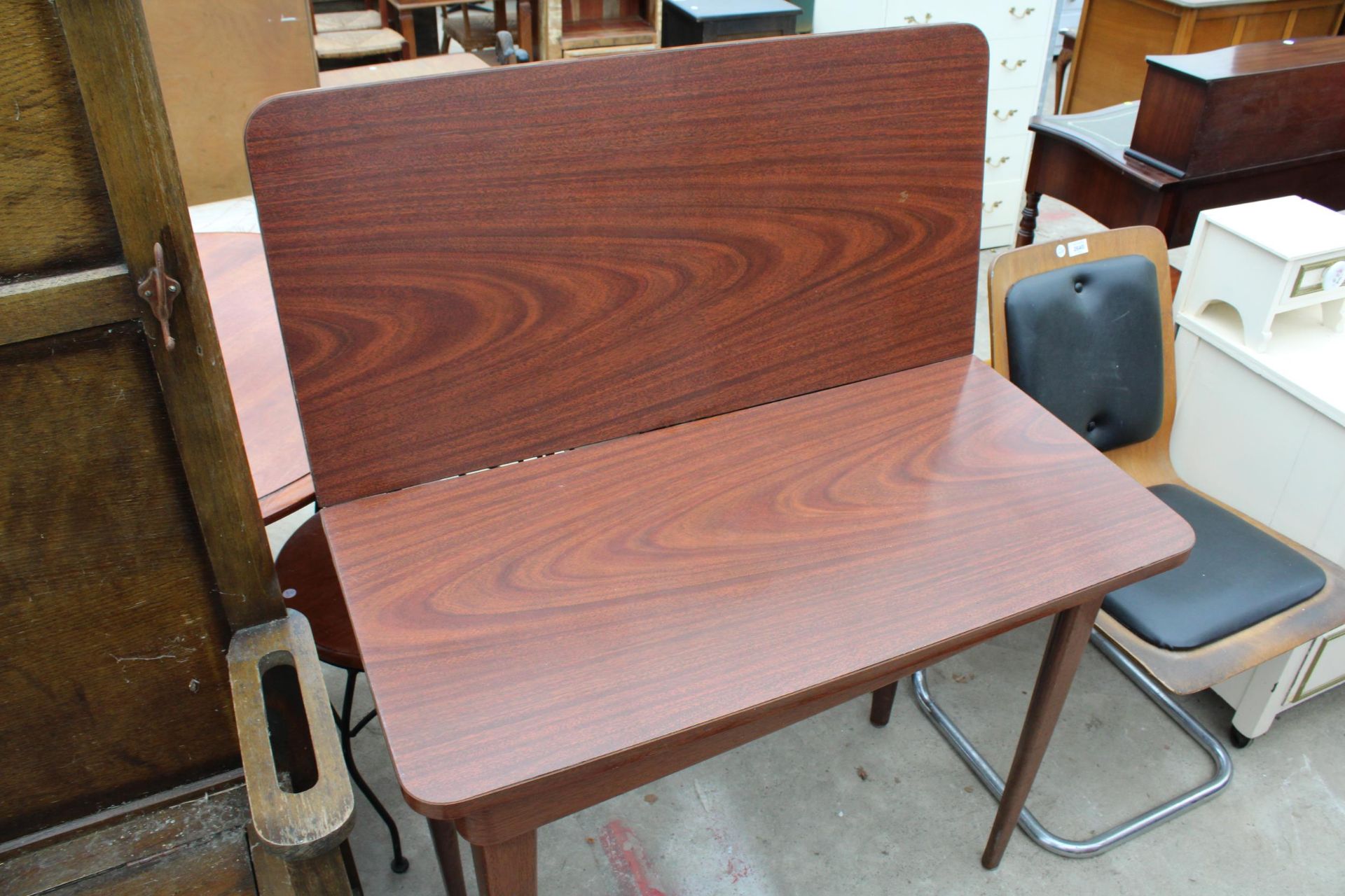 A MODERN FORMICA FOLD OVER TABLE ON METAL LEGS - Image 2 of 2