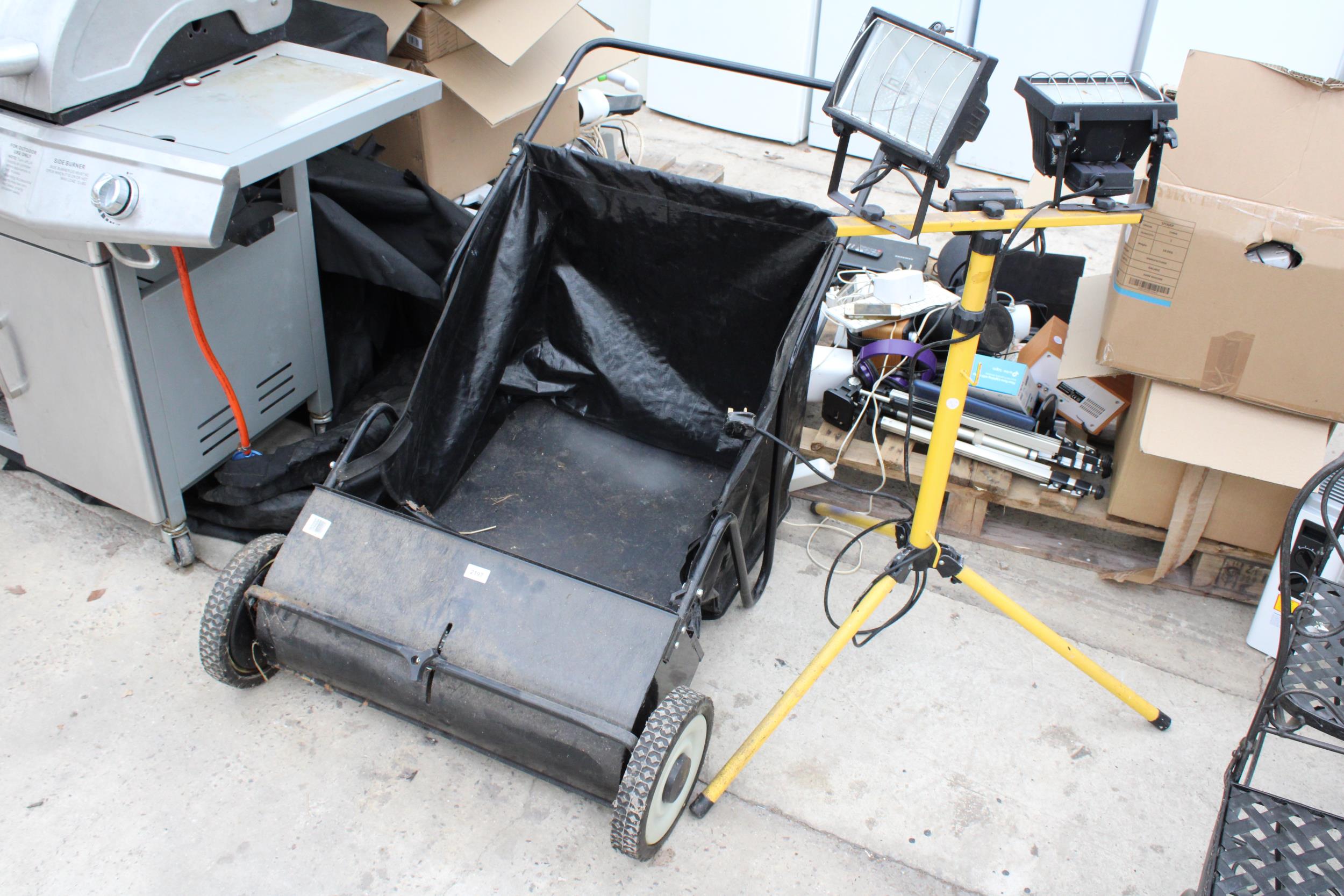 A MANUAL PUSH ALONG GARDEN LEAF SWEEPER AND A TRIPOD WORKLIGHT