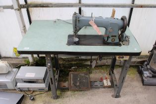 A VINTAGE SINGER INDUSTRIAL SEWING MACHINE WITH TREADLE BASE