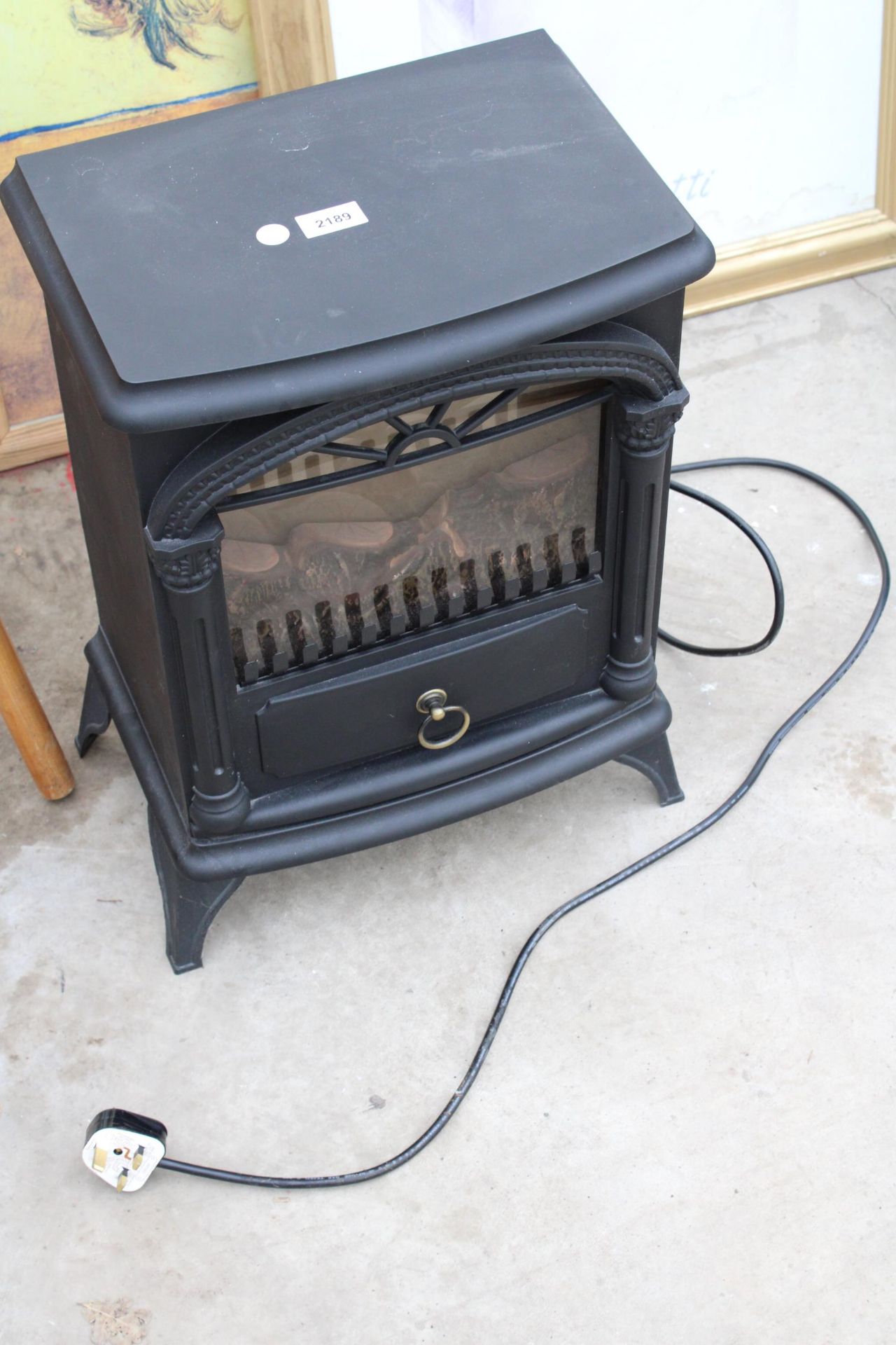 AN ELECTRIC FIRE IN THE FORM OF A LOG BURNER