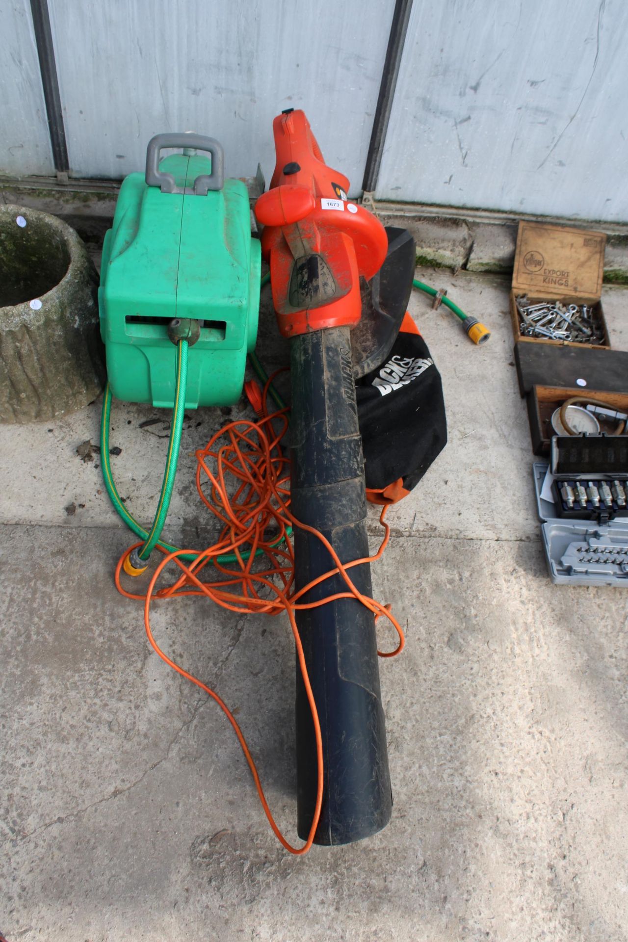 A BLACK AND DECKER ELECTRIC LEAF VAC AND A HOZELOCK REEL AND HOSE