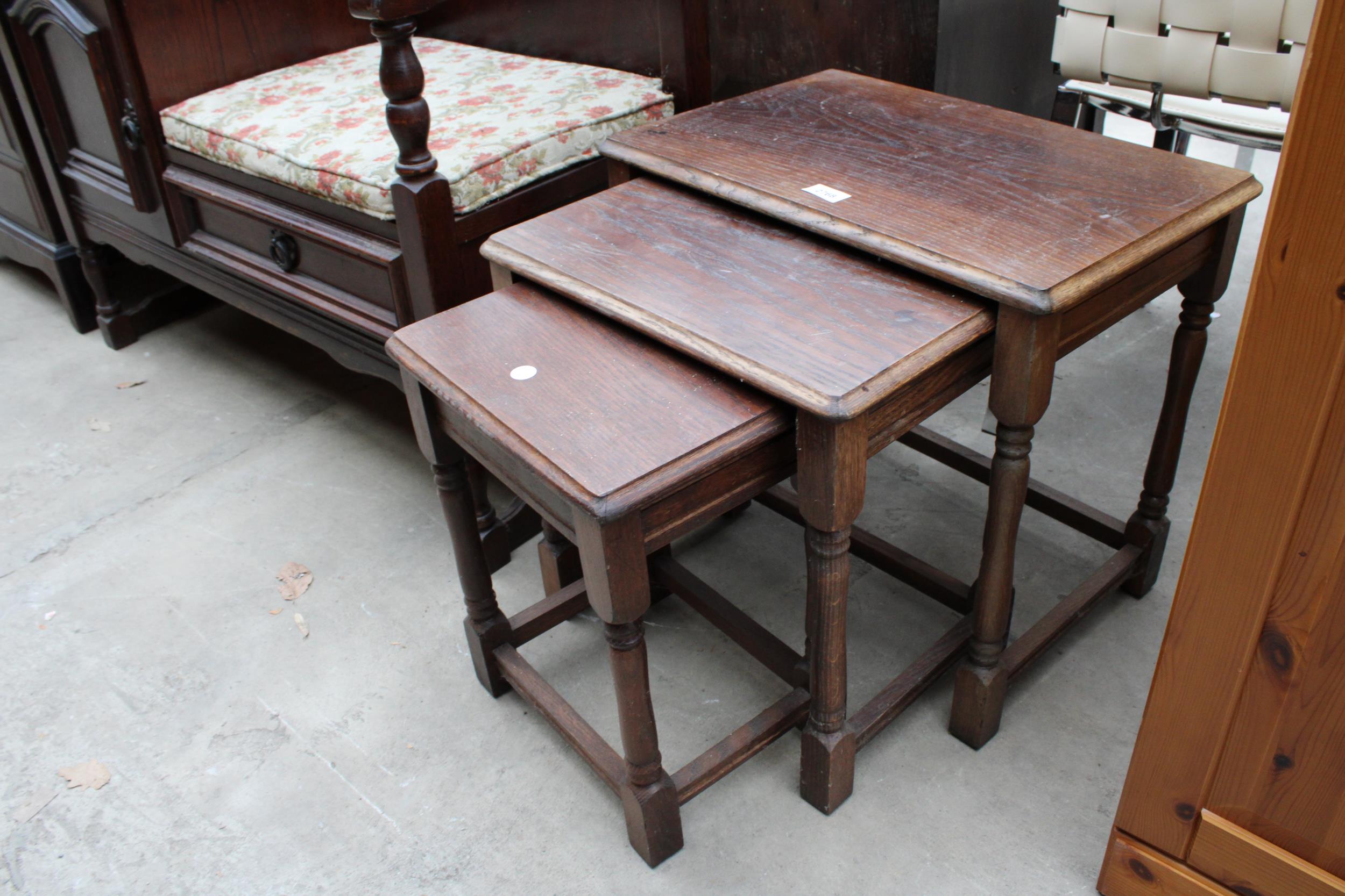 A NEST OF THREE OAK TABLES