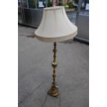 AN ONYX AND GILT STANDARD LAMP WITH SHADE