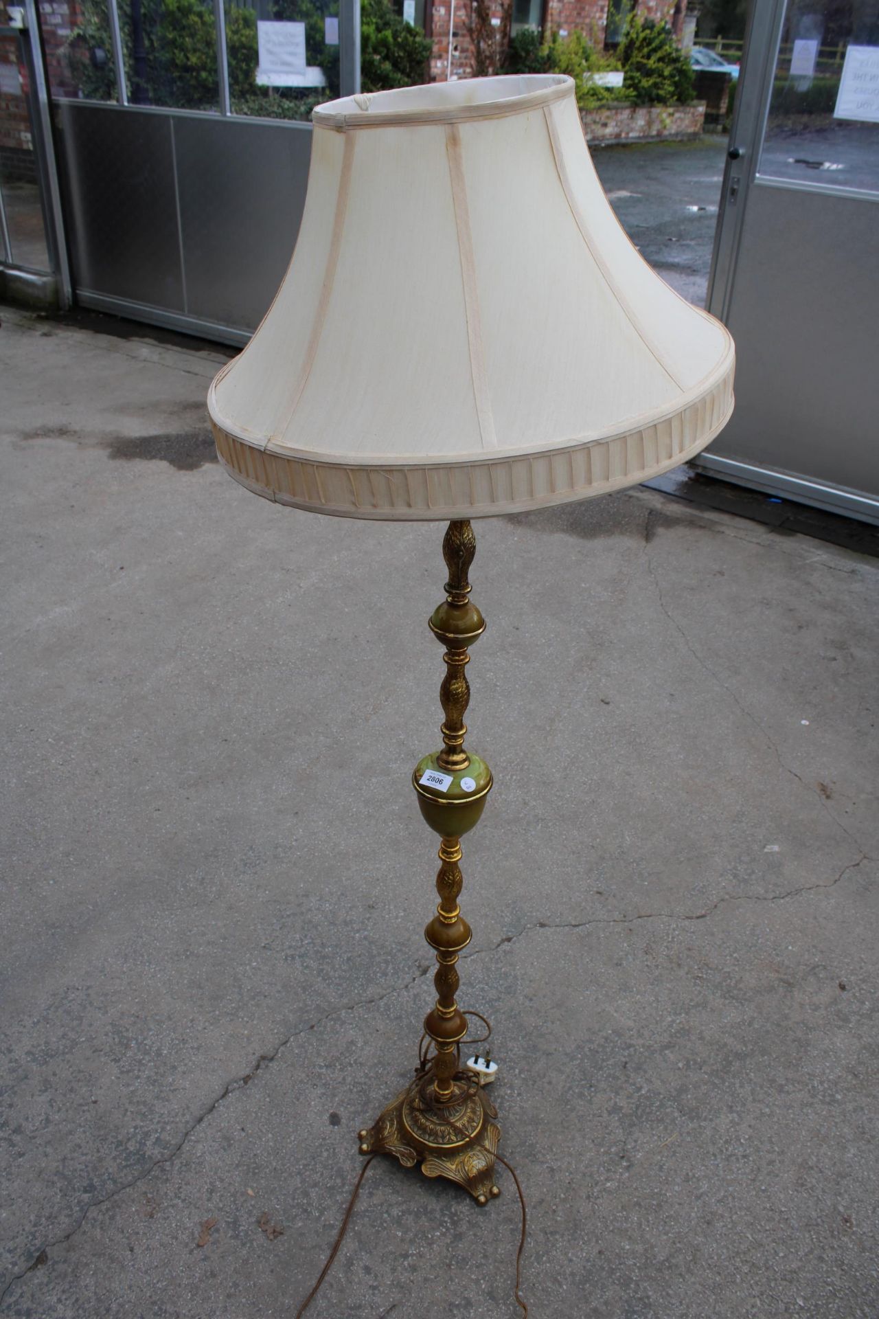 AN ONYX AND GILT STANDARD LAMP WITH SHADE