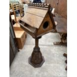 AN DOUBLE SIDED OAK CHOIR LECTERN WITH TURNED AND CARVED COLUMN