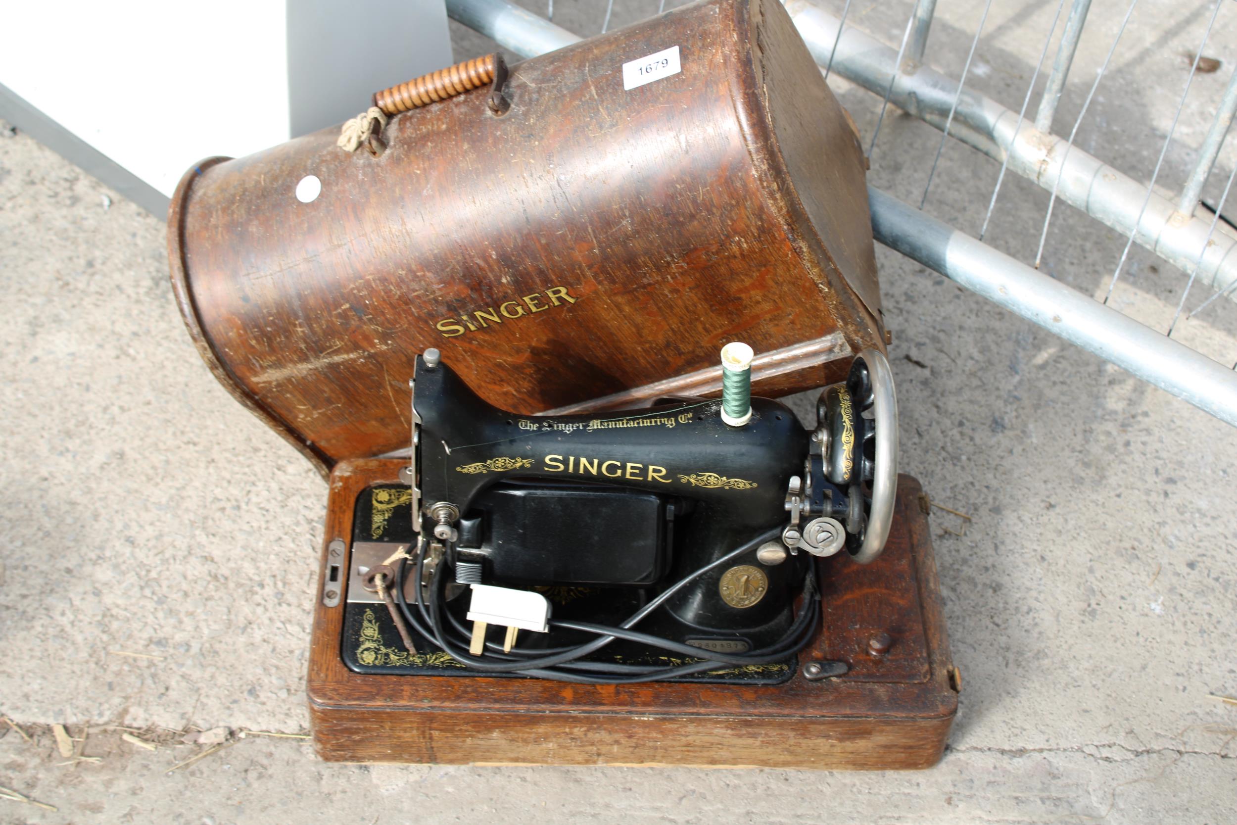 A VINTAGE SINGER SEWING MACHINE WITH WOODEN CARRY CASE