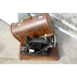 A VINTAGE SINGER SEWING MACHINE WITH WOODEN CARRY CASE