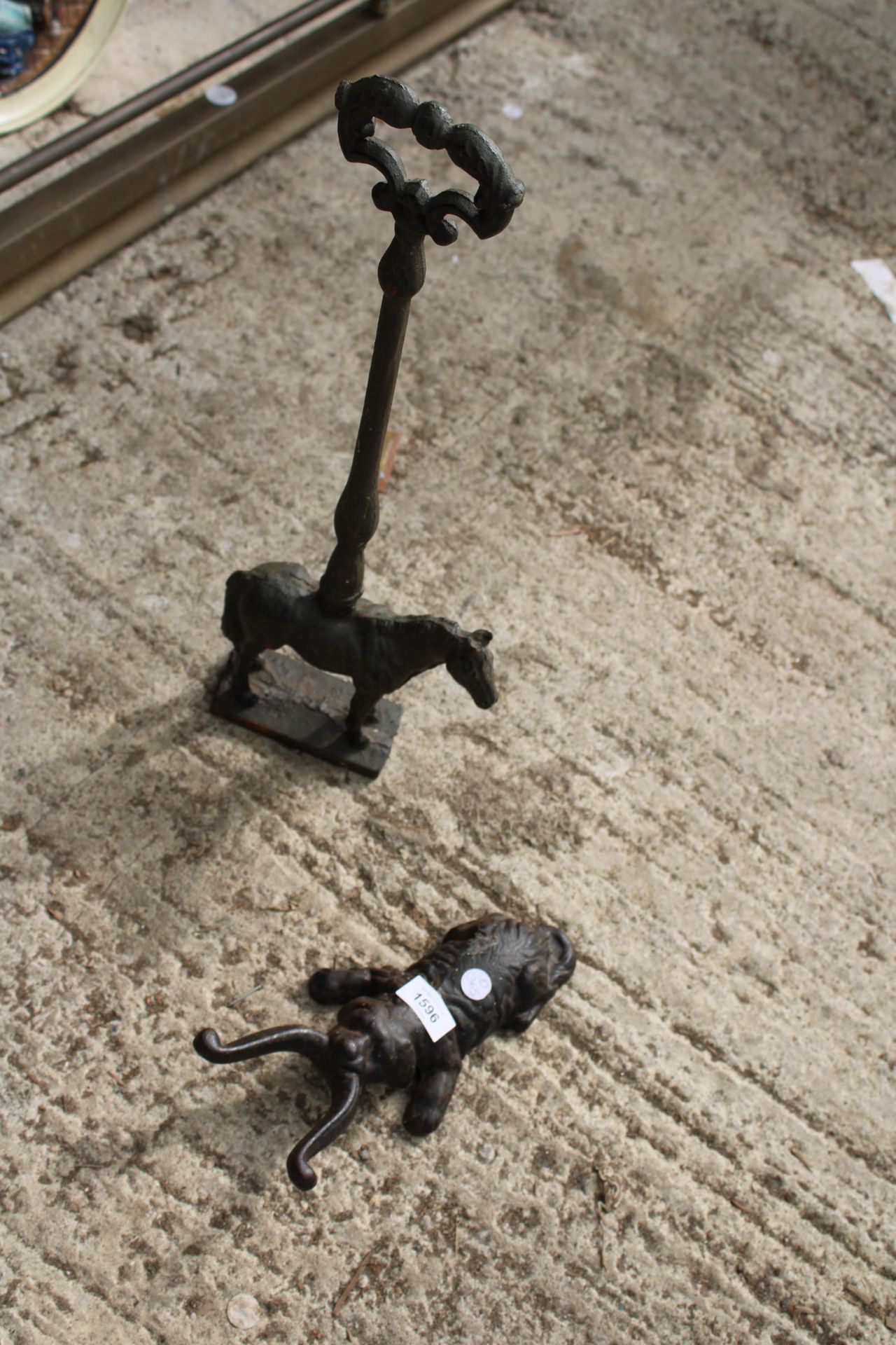 A VINTAGE CAST IRON HORSE DOOR STOP AND A DOG BOOT REMOVER