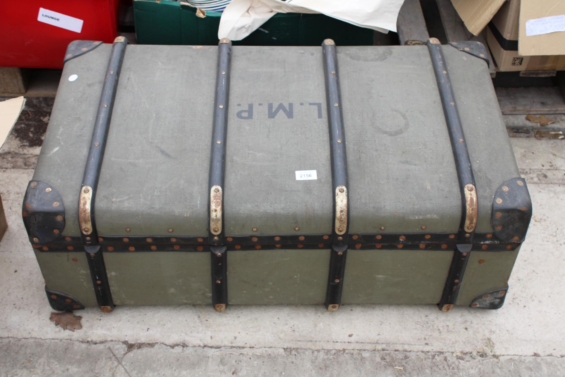 A VINTAGE COMPRESSED FIBRE TRAVEL TRUNK BEARING THE INITIALS L.M.P