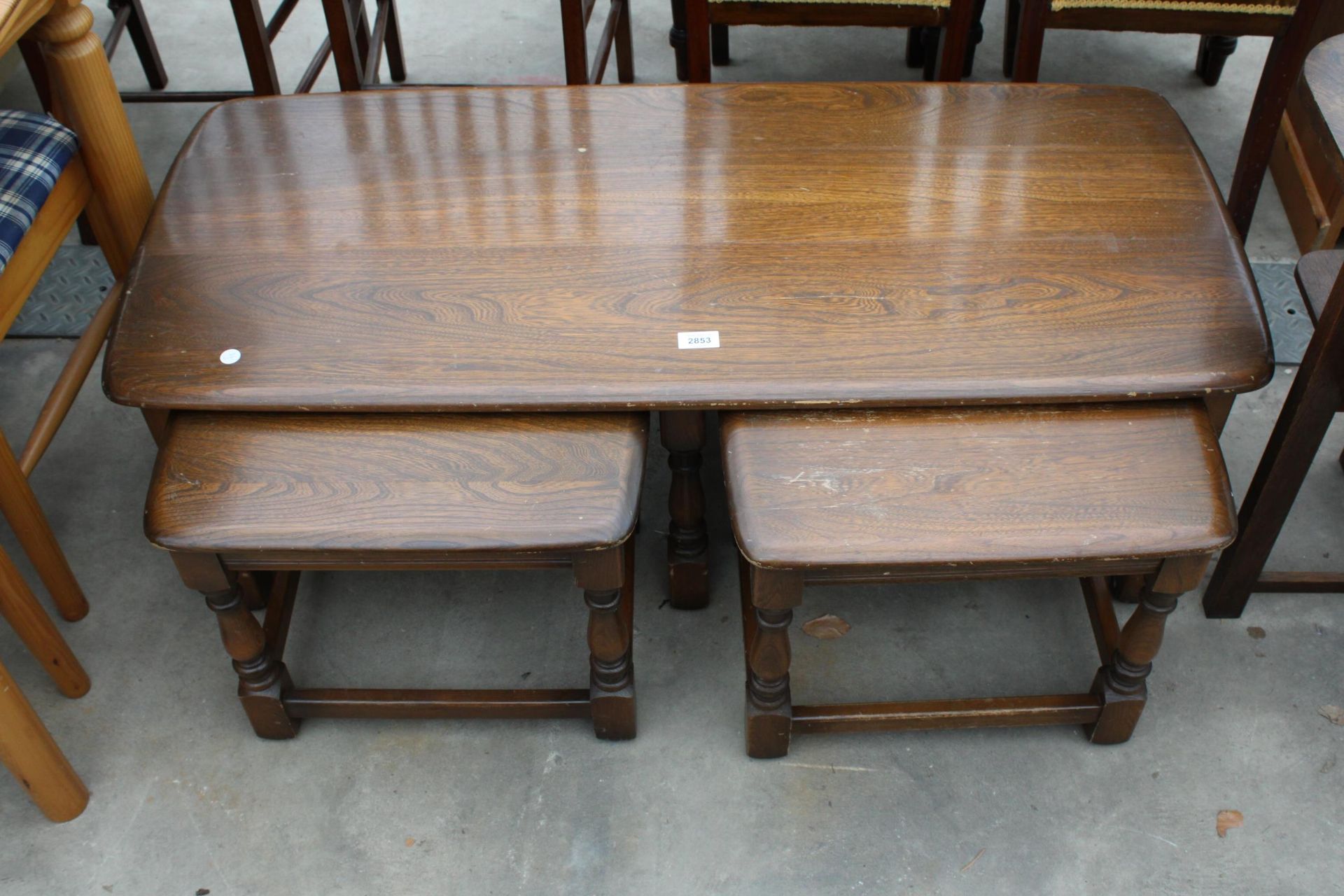 AN ELM ERCOL OLD COLONIAL STYLENEST OF THREE TABLES