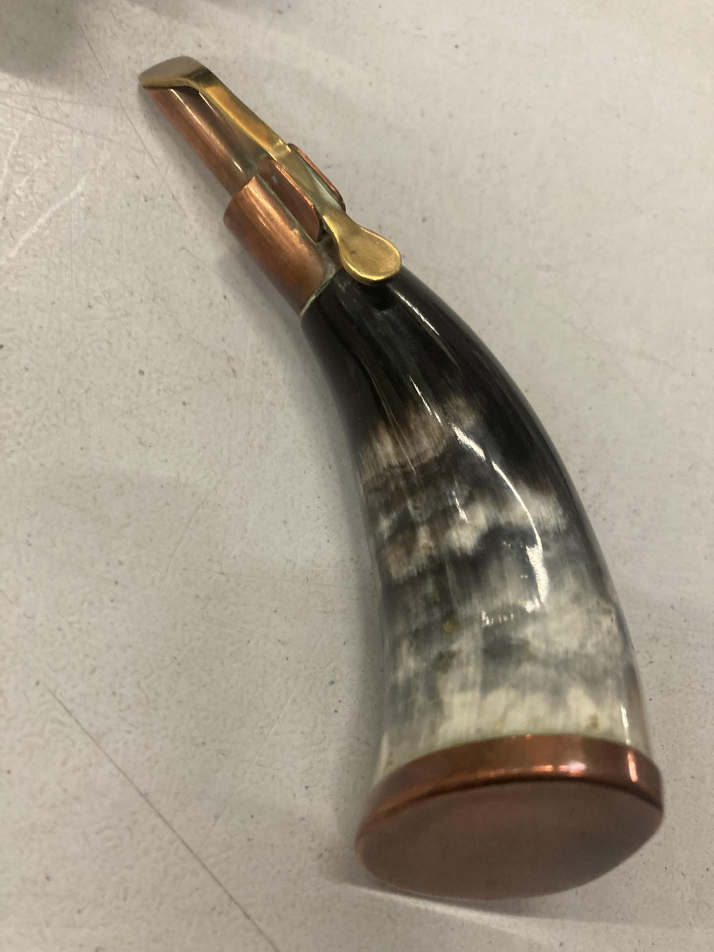 A COPPER AND HORN POWDER FLASK