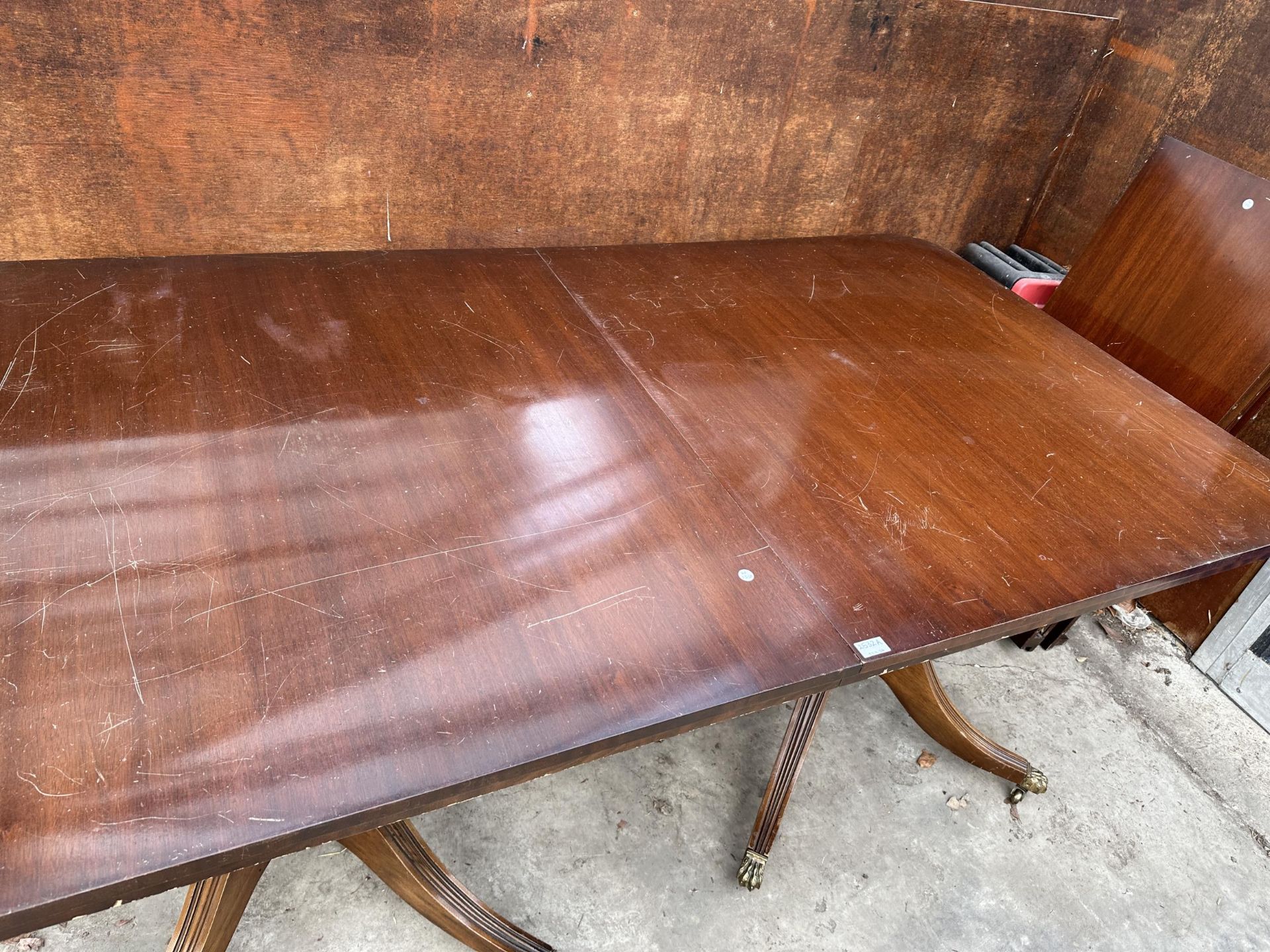 A MAHOGANY TWIN PEDESTAL DINING TABLE WITH THREE EXTRA LEAVES - Image 2 of 7