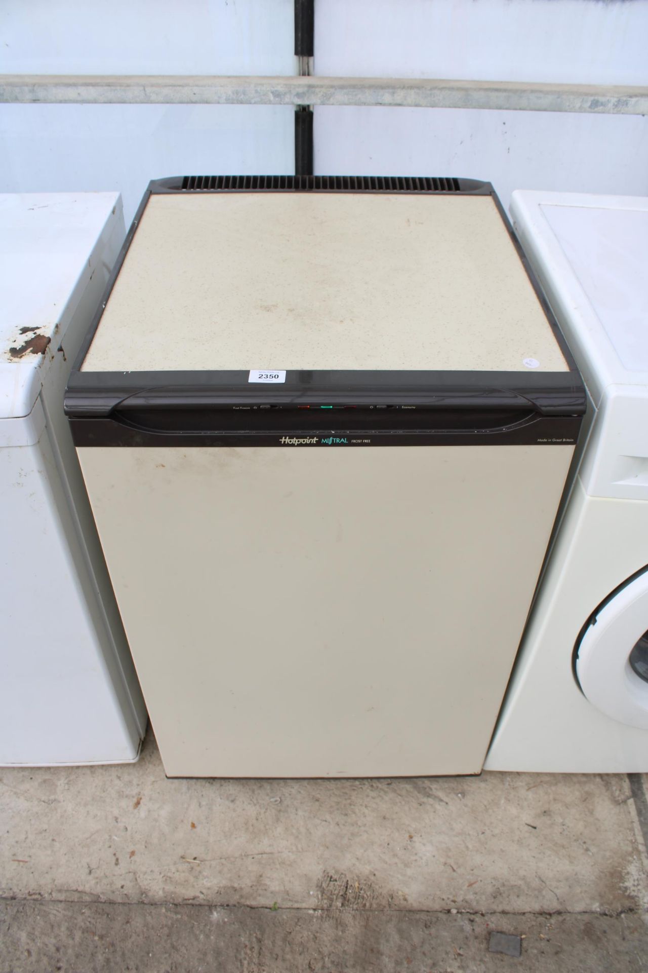 A BROWN AND CREAM HOTPOINT UNDER COUNTER FREEZER