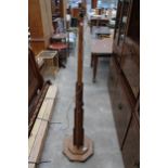 AN ART DECO OAK STEPPED AND TAPERING STANDARD LAMP ON OCTAGONAL BASE