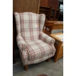 A CHECK PRINT H.S.L. PETITE WINGED FIRESIDE CHAIR ON TURNED FRONT LEGS