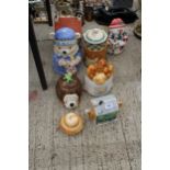 AN ASSORTMENT OF NOVELTY CERAMIC TEAPOTS AND BISCUIT BARRELS