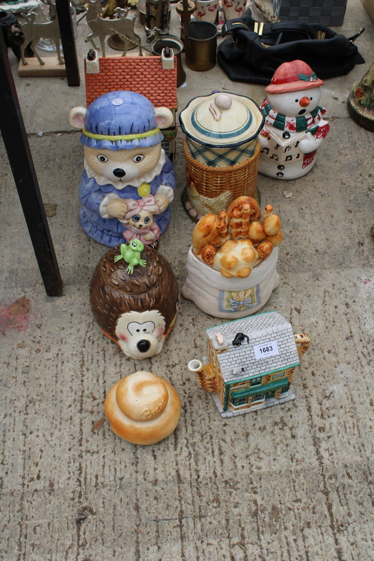 AN ASSORTMENT OF NOVELTY CERAMIC TEAPOTS AND BISCUIT BARRELS