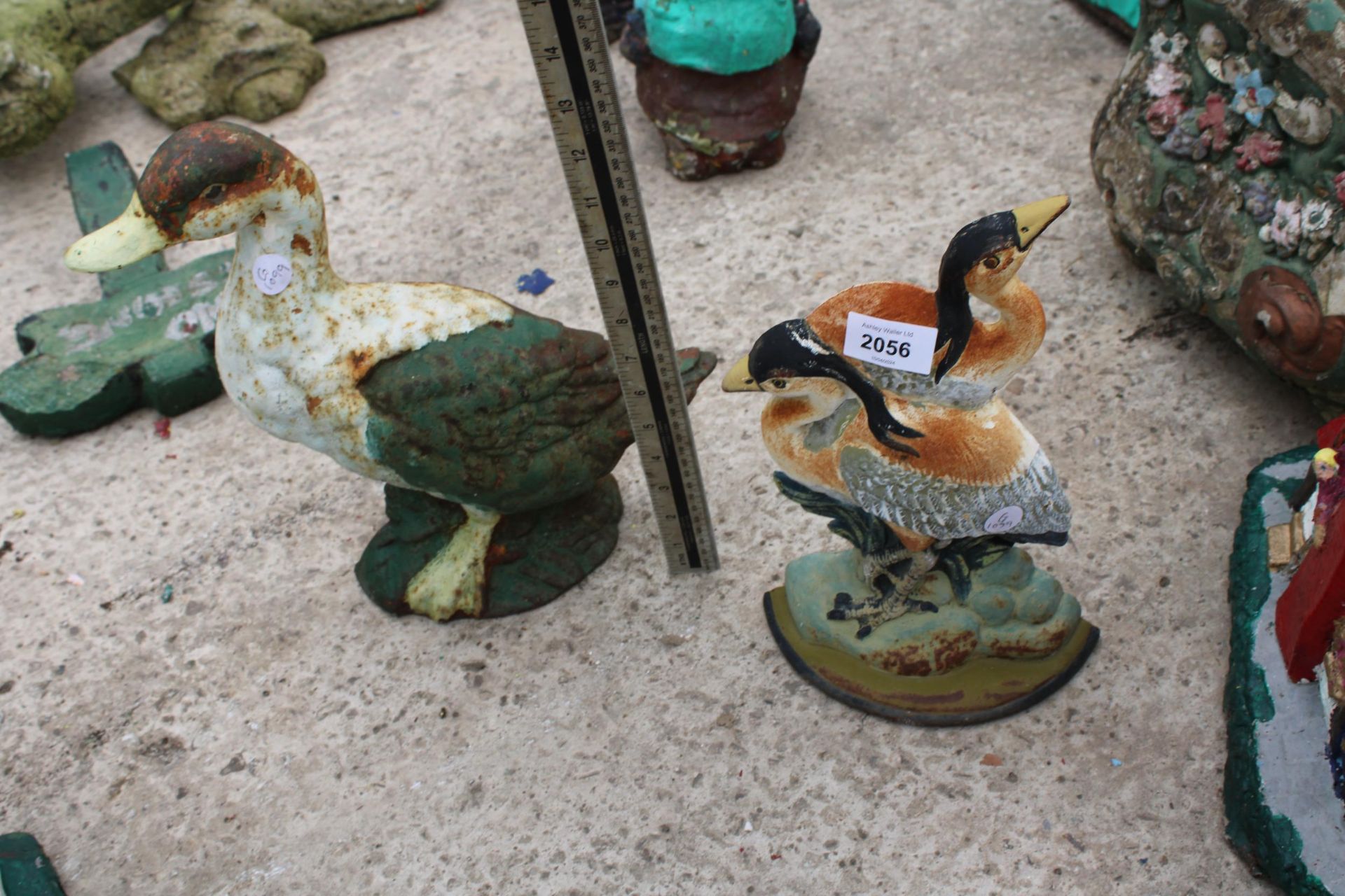 TWO VINTAGE CAST IRON BIRD DOOR STOPS