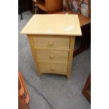 A MODERN OAK OUTLOOK INTERNATIONAL BEDSIDE CHEST OF THREE DRAWERS