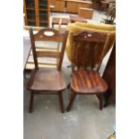 A MID TWENTIETH CENTURY OAK LADDER BACK CHAIR AND HARDWOOD KITCHEN CHAIR