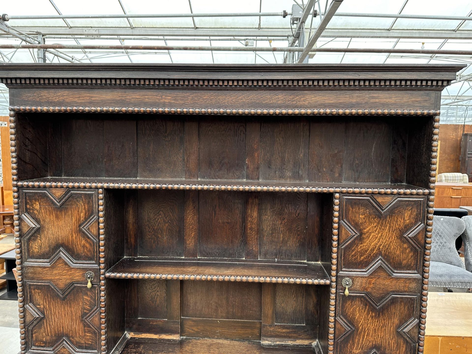 AN OAK JACOBEAN STYLE DRESSER WITH TWO FOLD-D0WN COMPARTMENTS AND A PLATE RACK ENCLOSING CUPBOARD - Image 2 of 7