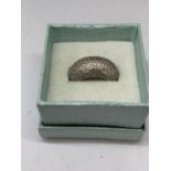 A SILVER RING IN A PRESENTATION BOX