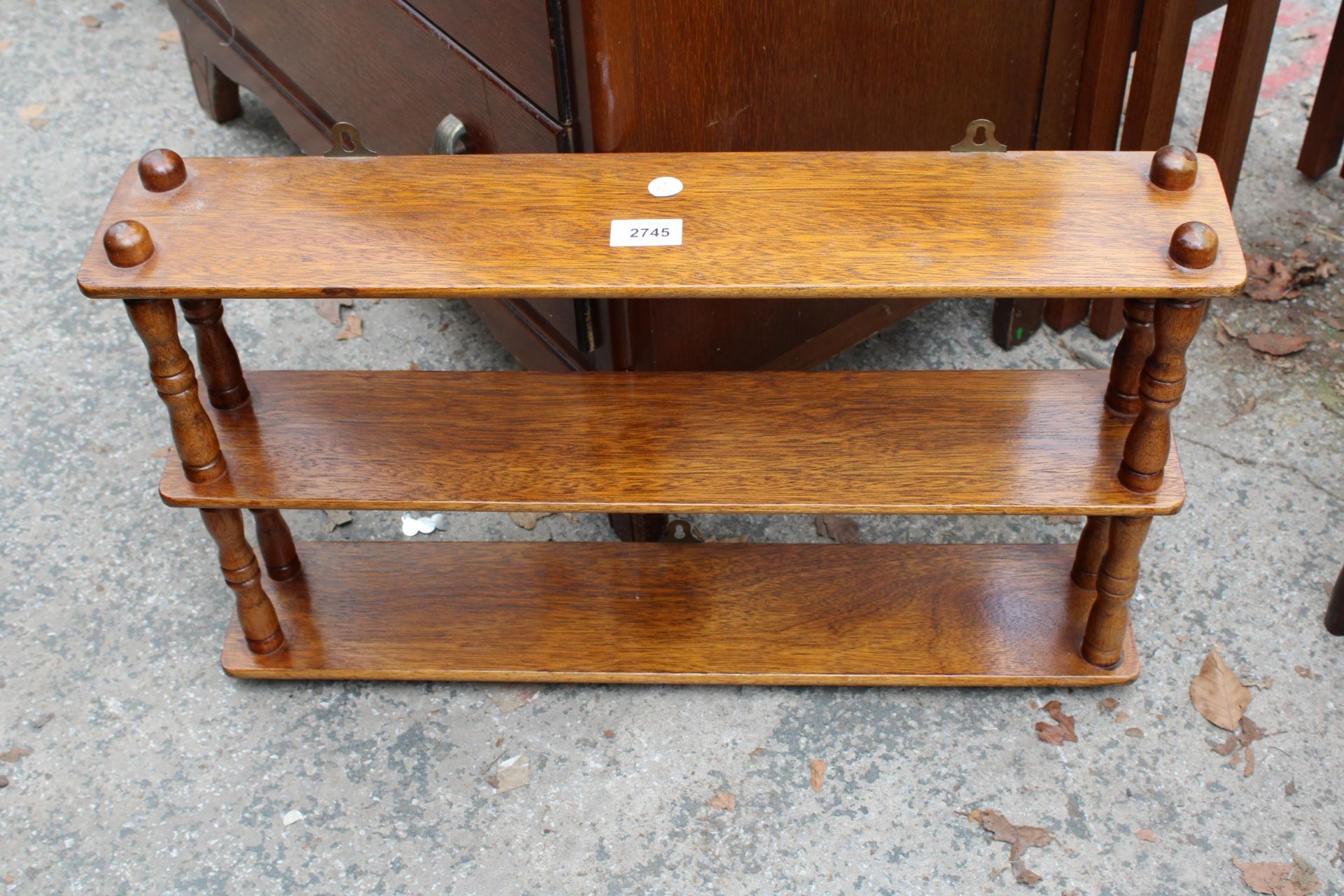 A SMALL OAK THREE TIER WALL SHELF, 24" WIDE