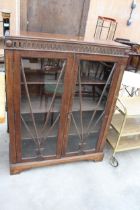 AN EARLY 20TH CENTURY OAK TWO DOOR GLAZED BOOKCASE, 36" WIDE